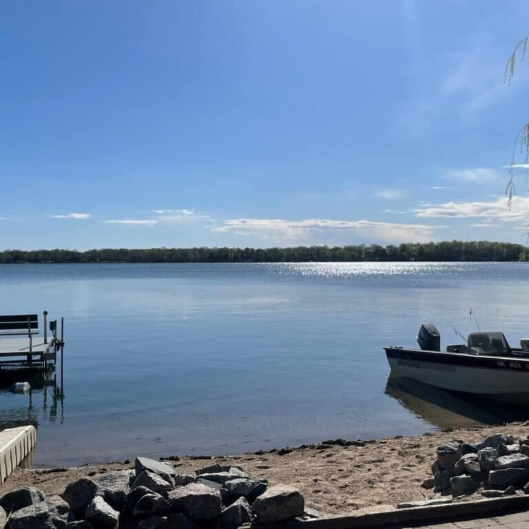 Clear lake shore with dock and boat