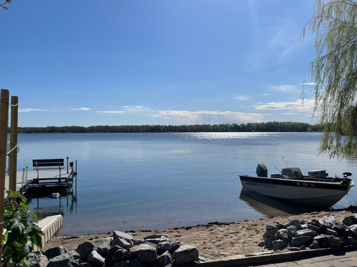 Clear lake shore with dock and boat