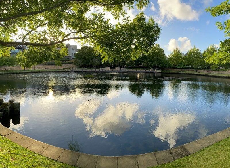 Enclosed pond with sky reflection